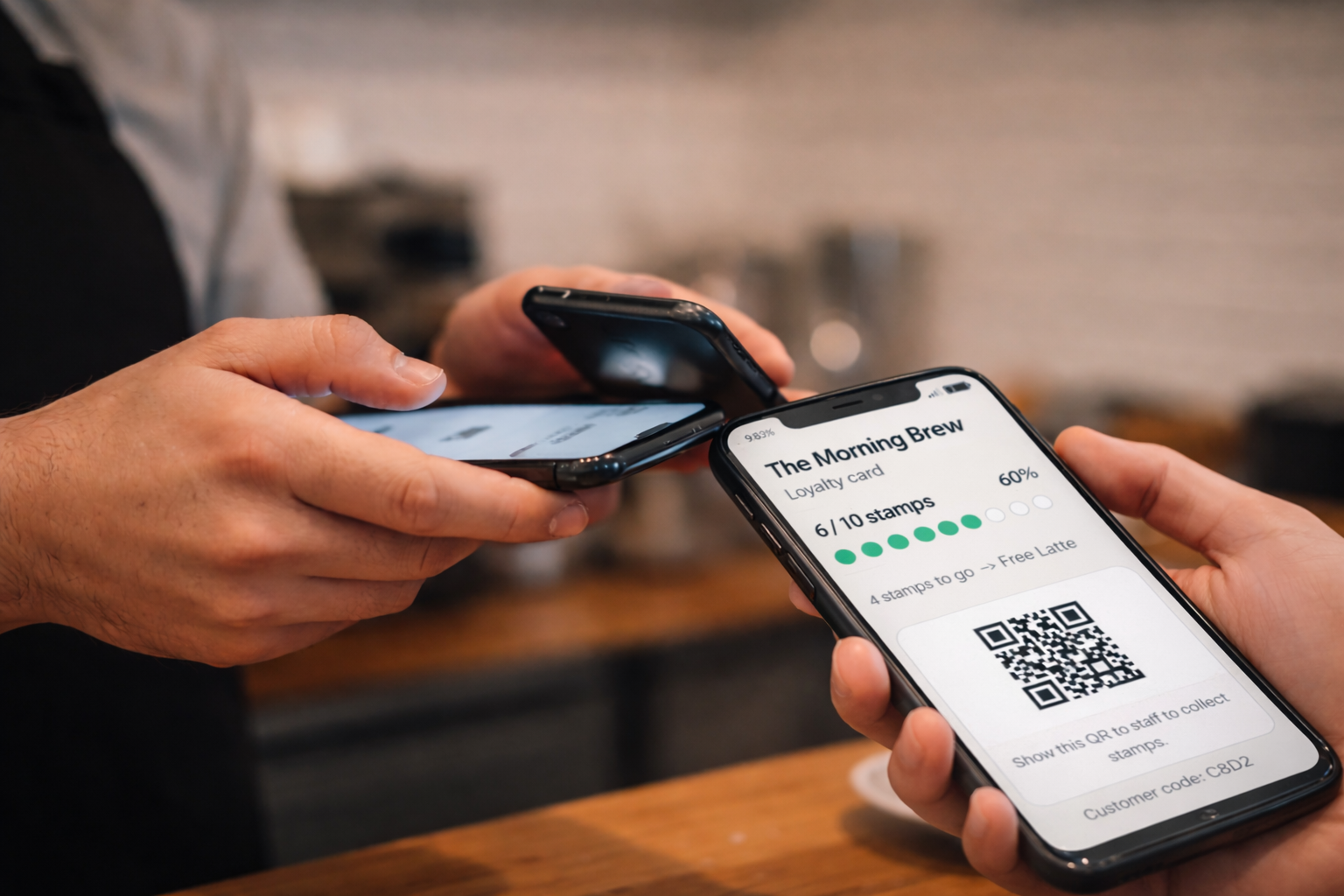 Staff member scanning a customer loyalty card on phone and tapping plus one in StampBoost